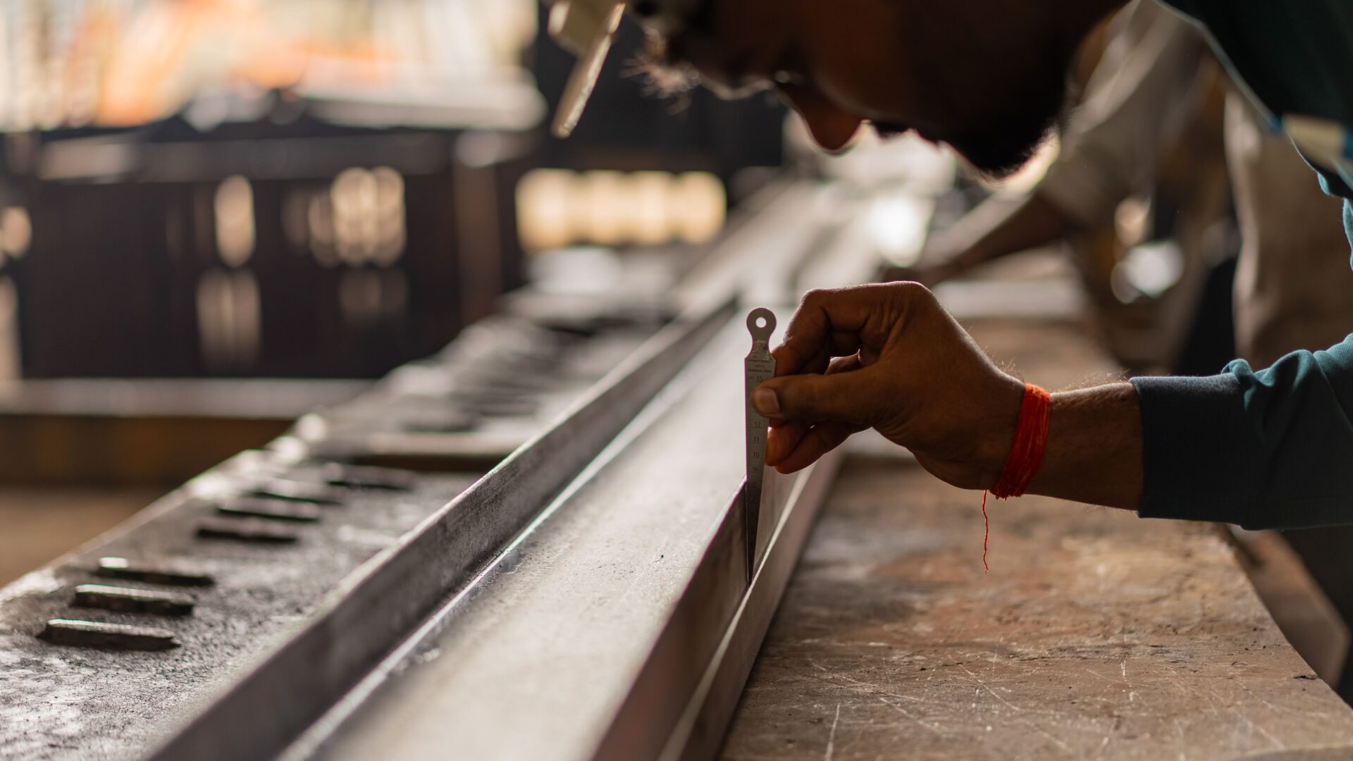 Technician using precision gauge for equipment calibration in Perth workshop, Western Australia